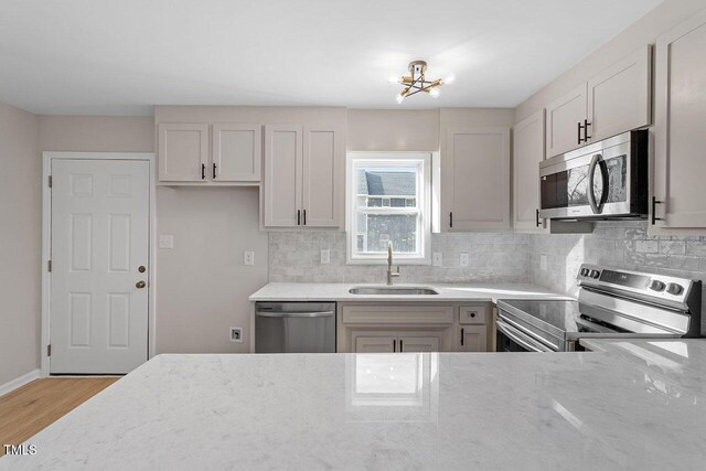 407 E Williams St, Angier, NC 27501 - kitchen featuring stainless steel appliances, light stone counters, and tasteful backsplash