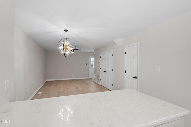 407 E Williams St, Angier, NC 27501 - unfurnished dining area with light wood-style flooring and a chandelier