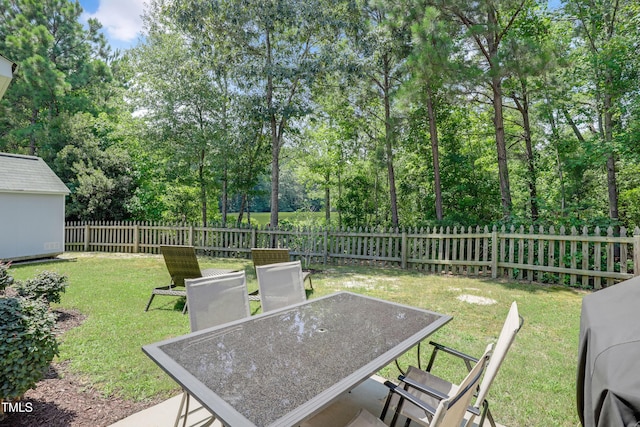 118 Tweedbank Ct, Fuquay Varina, NC 27526 - fenced backyard with outdoor dining space and view of wooded area