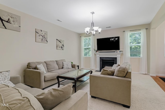 118 Tweedbank Ct, Fuquay Varina, NC 27526 - living room featuring healthy amount of natural light, a chandelier, a fireplace, and light colored carpet