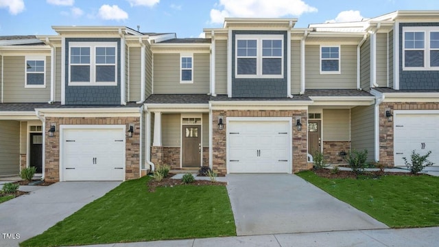 1923 Hinesley Dr, Durham, NC 27703 - multi unit property featuring an attached garage, concrete driveway, stone siding, and a front lawn