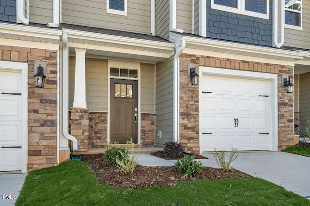 1923 Hinesley Dr, Durham, NC 27703 - view of exterior entry with stone siding, an attached garage, covered porch, and driveway