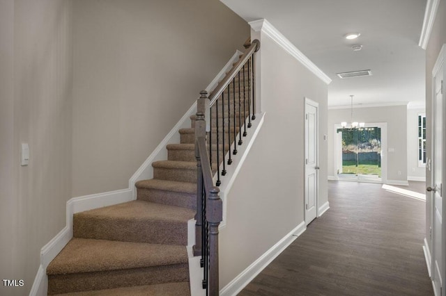 1923 Hinesley Dr, Durham, NC 27703 - stairway featuring wood finished floors, a chandelier, and crown molding