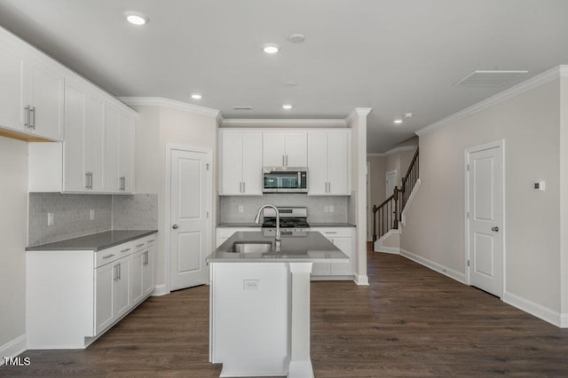 1923 Hinesley Dr, Durham, NC 27703 - kitchen featuring appliances with stainless steel finishes, ornamental molding, backsplash, dark wood finished floors, and recessed lighting