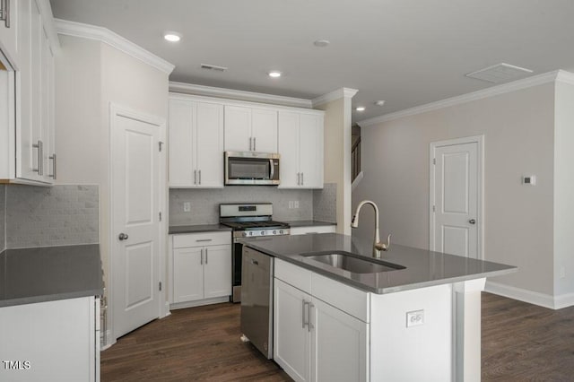 1923 Hinesley Dr, Durham, NC 27703 - kitchen with appliances with stainless steel finishes, crown molding, dark countertops, dark wood finished floors, and tasteful backsplash