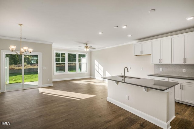 1923 Hinesley Dr, Durham, NC 27703 - kitchen featuring dark countertops, crown molding, a chandelier, tasteful backsplash, and open floor plan