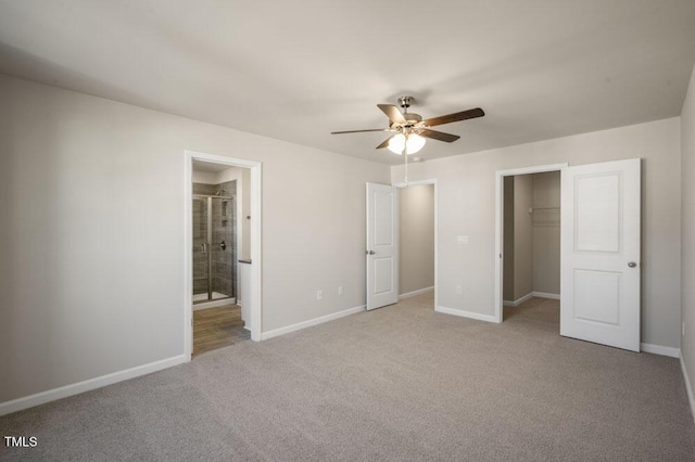 1923 Hinesley Dr, Durham, NC 27703 - unfurnished bedroom featuring carpet, a closet, a spacious closet, ceiling fan, and connected bathroom