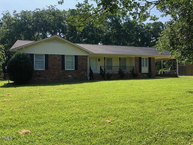 5018 Gatewood Dr, Durham, NC 27712 - ranch-style house with covered porch, a front lawn, and brick siding