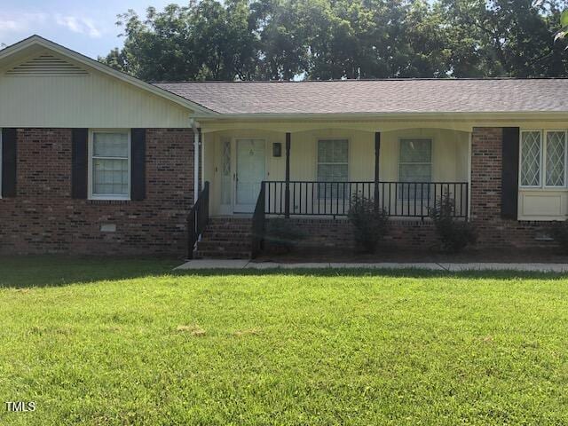 5018 Gatewood Dr, Durham, NC 27712 - ranch-style home featuring covered porch, a front yard, and brick siding