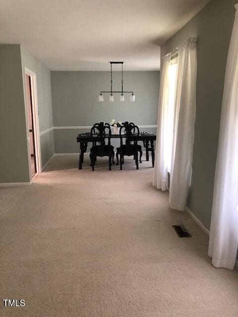 5018 Gatewood Dr, Durham, NC 27712 - dining room featuring light carpet and baseboards
