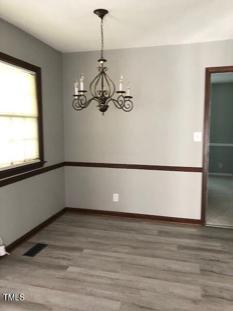 5018 Gatewood Dr, Durham, NC 27712 - empty room with light wood-style floors and a chandelier