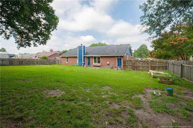 2517 Previs Rd, Fayetteville, NC 28306 - back of property featuring a garden, a fenced backyard, and brick siding