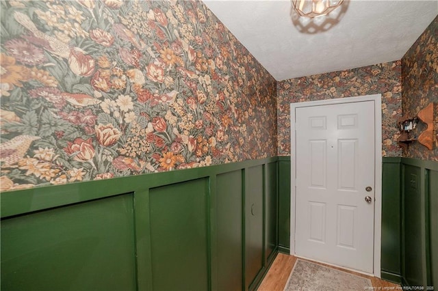 2517 Previs Rd, Fayetteville, NC 28306 - doorway with wallpapered walls, wainscoting, and light wood-type flooring