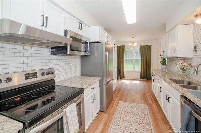 2517 Previs Rd, Fayetteville, NC 28306 - kitchen featuring appliances with stainless steel finishes, under cabinet range hood, white cabinets, and light wood finished floors