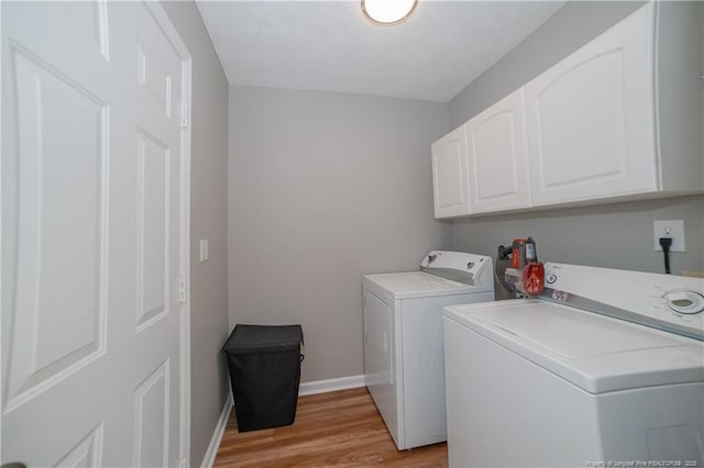 2517 Previs Rd, Fayetteville, NC 28306 - washroom featuring washing machine and dryer, cabinet space, and light wood-style flooring