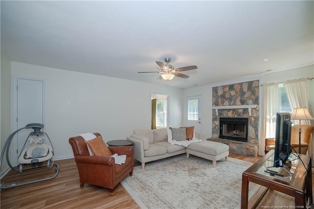 2517 Previs Rd, Fayetteville, NC 28306 - living room featuring light wood finished floors, plenty of natural light, a fireplace, and ceiling fan