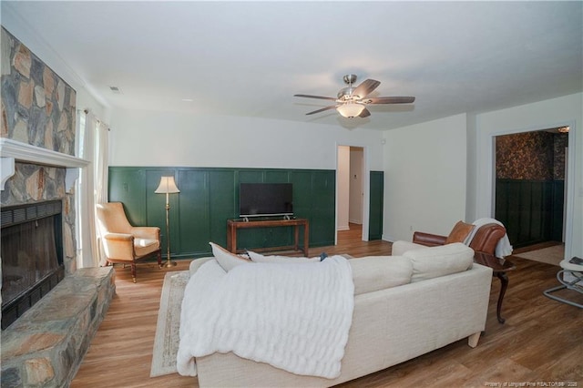 2517 Previs Rd, Fayetteville, NC 28306 - living room featuring a fireplace, wood finished floors, and a ceiling fan