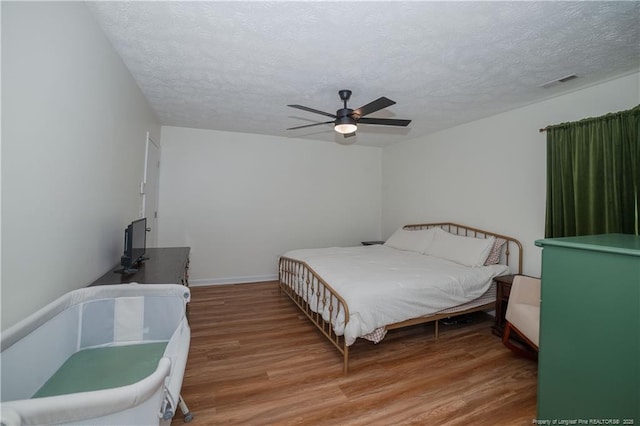 2517 Previs Rd, Fayetteville, NC 28306 - bedroom with wood finished floors, a textured ceiling, and ceiling fan