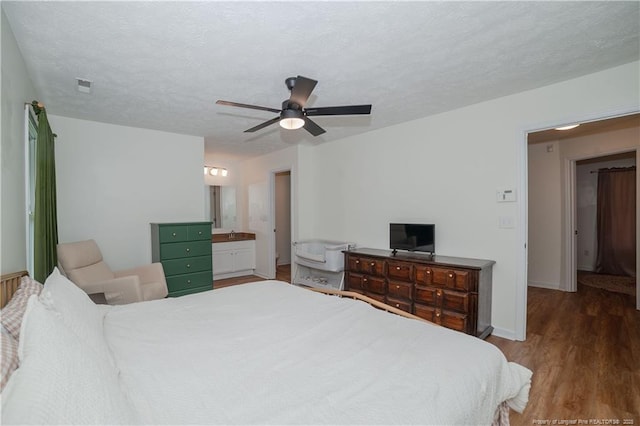 2517 Previs Rd, Fayetteville, NC 28306 - bedroom with wood finished floors, a ceiling fan, ensuite bath, and a textured ceiling