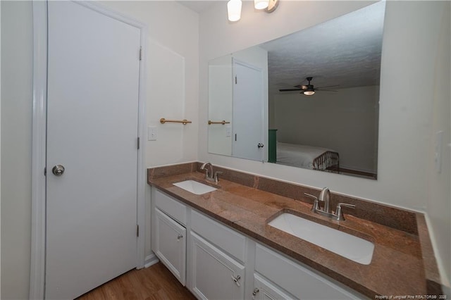 2517 Previs Rd, Fayetteville, NC 28306 - ensuite bathroom with double vanity, wood finished floors, and ceiling fan
