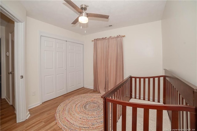 2517 Previs Rd, Fayetteville, NC 28306 - bedroom featuring light wood-style floors, a closet, a ceiling fan, and a crib
