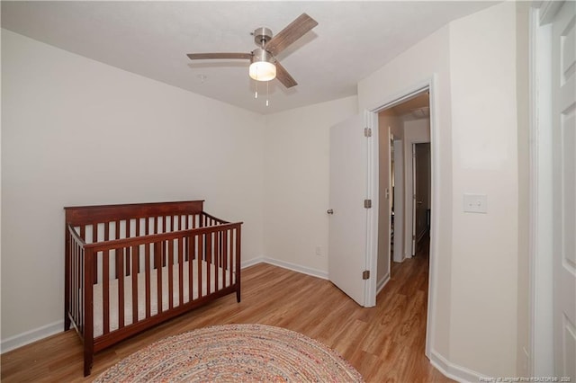 2517 Previs Rd, Fayetteville, NC 28306 - bedroom with light wood-style floors, a ceiling fan, and a crib