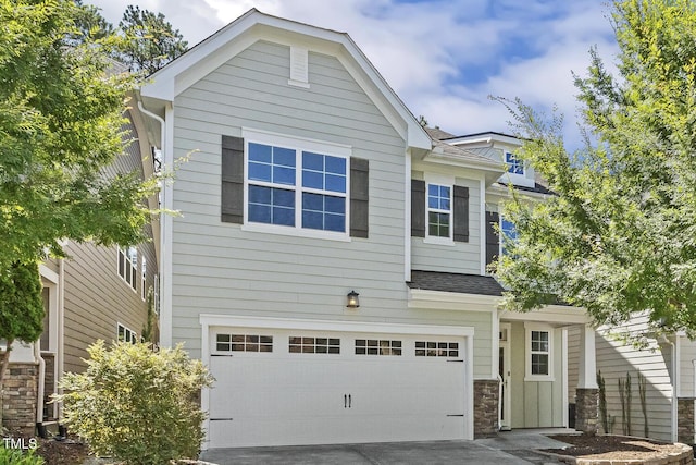 261 Begen St, Morrisville, NC 27560 - craftsman-style house featuring a garage, concrete driveway, a shingled roof, and stone siding