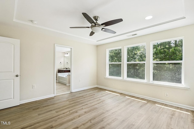 261 Begen St, Morrisville, NC 27560 - unfurnished bedroom with multiple windows, light wood-style floors, connected bathroom, and a ceiling fan