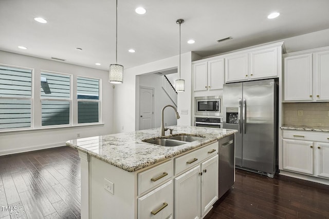 261 Begen St, Morrisville, NC 27560 - kitchen with stainless steel appliances, dark wood-type flooring, tasteful backsplash, white cabinetry, and recessed lighting