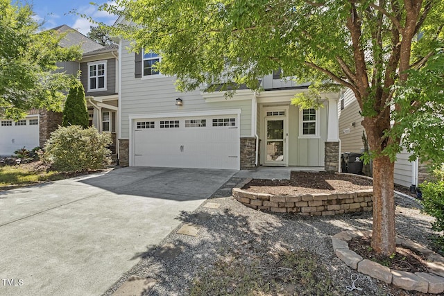 261 Begen St, Morrisville, NC 27560 - view of front facade with concrete driveway, board and batten siding, stone siding, and an attached garage
