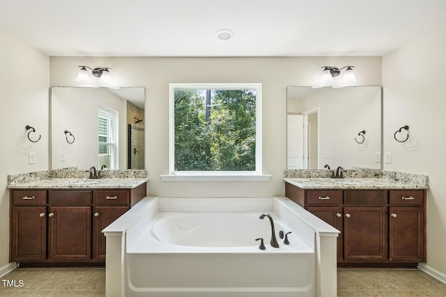261 Begen St, Morrisville, NC 27560 - full bath with a bath, two vanities, a stall shower, and tile patterned flooring