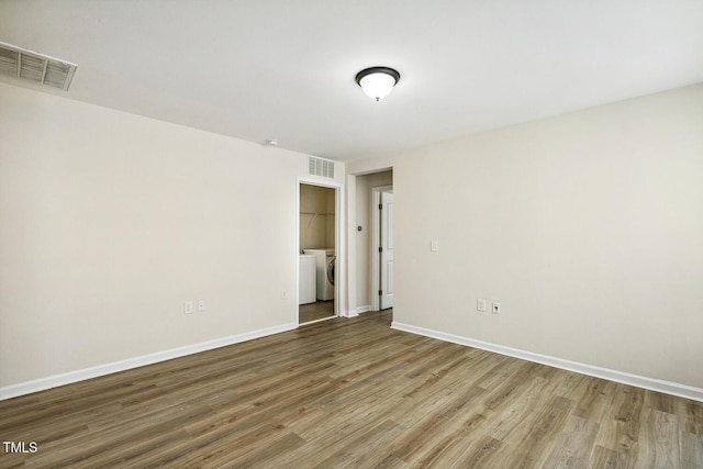261 Begen St, Morrisville, NC 27560 - spare room featuring wood finished floors and washer and dryer