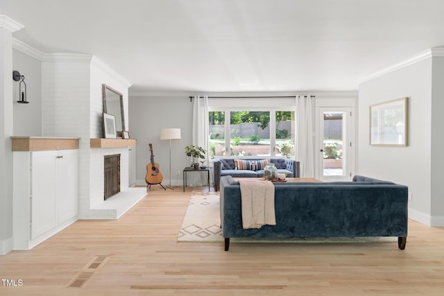 317 Reade Rd, Chapel Hill, NC 27516 - living area with light wood finished floors, crown molding, and a fireplace