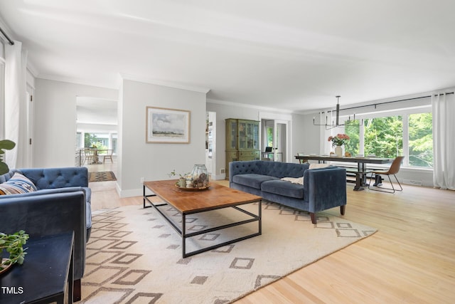317 Reade Rd, Chapel Hill, NC 27516 - living room featuring crown molding, light wood finished floors, and a chandelier