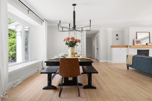 317 Reade Rd, Chapel Hill, NC 27516 - dining area featuring a chandelier, ornamental molding, and light wood-style flooring