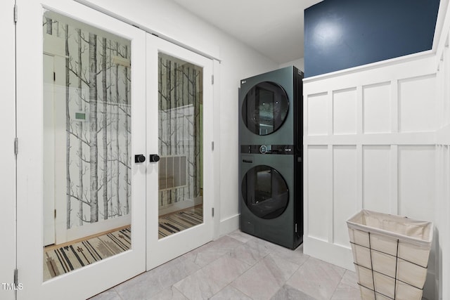 317 Reade Rd, Chapel Hill, NC 27516 - washroom with estacked washer and dryer, light marble finish flooring, and french doors
