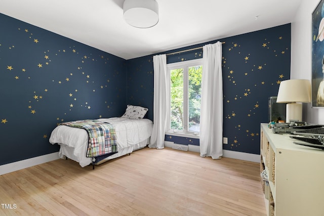 317 Reade Rd, Chapel Hill, NC 27516 - bedroom featuring wallpapered walls, light wood-type flooring, and an accent wall