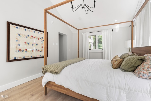 317 Reade Rd, Chapel Hill, NC 27516 - bedroom featuring a chandelier, wood finished floors, and lofted ceiling