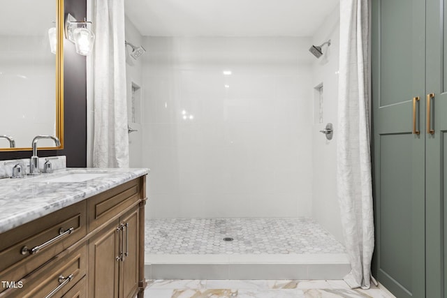 317 Reade Rd, Chapel Hill, NC 27516 - bathroom with a tile shower, vanity, and marble look tiles