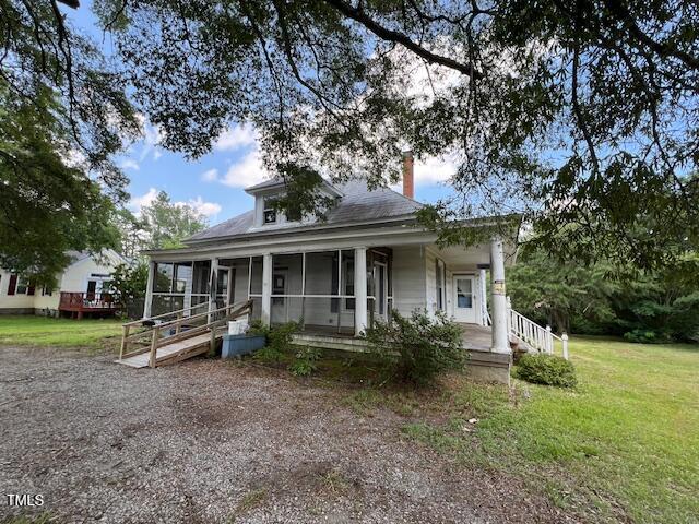 401 Division St, Norlina, NC 27563 - country-style home featuring a sunroom, a chimney, and a front yard