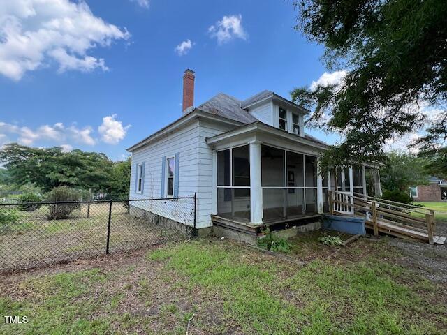 401 Division St, Norlina, NC 27563 - view of home's exterior featuring a sunroom and a chimney
