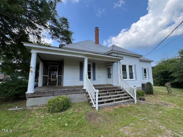 401 Division St, Norlina, NC 27563 - view of front of property with a porch, a front yard, and a chimney
