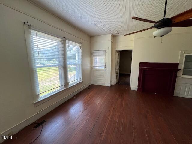 401 Division St, Norlina, NC 27563 - unfurnished living room with wood finished floors, plenty of natural light, and a ceiling fan