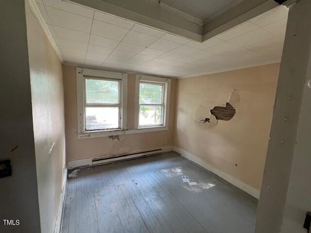 401 Division St, Norlina, NC 27563 - unfurnished room with a baseboard radiator, ornamental molding, and hardwood / wood-style flooring