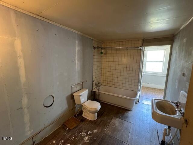401 Division St, Norlina, NC 27563 - bathroom featuring hardwood / wood-style flooring, shower / washtub combination, and crown molding