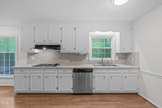 5313 Falkirk Dr, Durham, NC 27712 - kitchen featuring dishwasher, under cabinet range hood, black electric stovetop, white cabinets, and tile counters