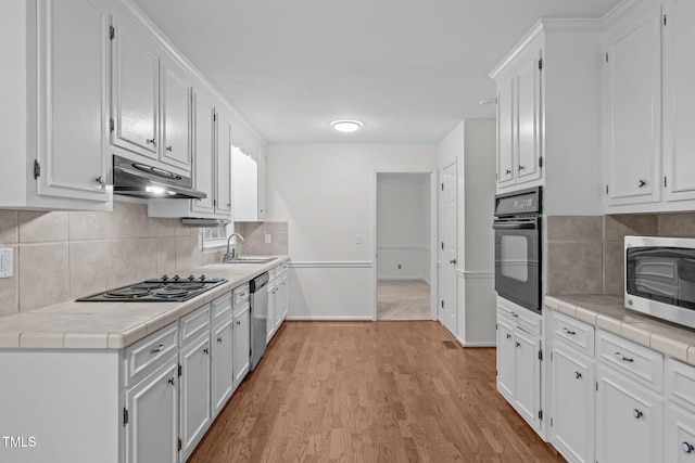 5313 Falkirk Dr, Durham, NC 27712 - kitchen featuring black appliances, under cabinet range hood, and white cabinetry