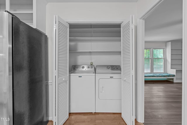 5313 Falkirk Dr, Durham, NC 27712 - washroom featuring washing machine and clothes dryer and light wood-style floors