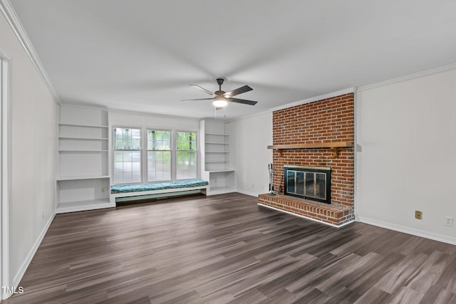 5313 Falkirk Dr, Durham, NC 27712 - unfurnished living room featuring wood finished floors, ceiling fan, a brick fireplace, built in features, and crown molding