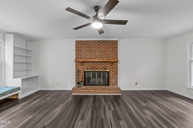 5313 Falkirk Dr, Durham, NC 27712 - unfurnished living room featuring wood finished floors, ornamental molding, built in shelves, ceiling fan, and a brick fireplace
